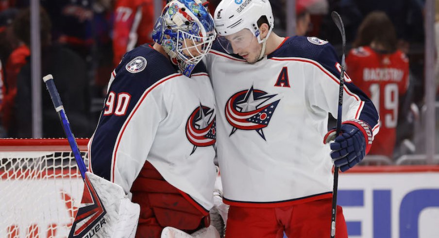 Columbus Blue Jackets' Elvis Merzlikins and Zach Werenski celebrate their win over the Washington Capitals at Capital One Arena.