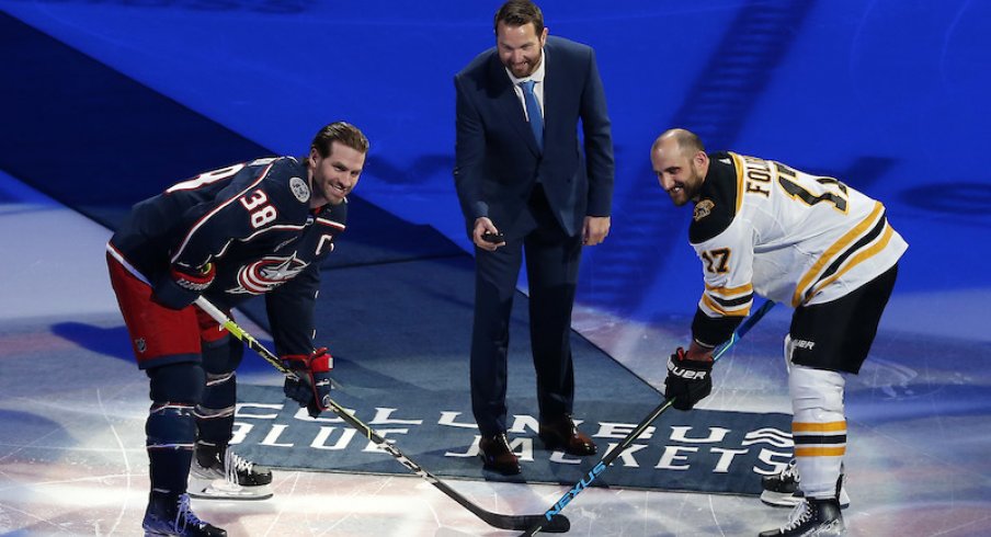 Rick Nash drops the puck for the ceremonial face-off between Columbus Blue Jackets captain Boone Jenner and Boston Bruins' Nick Foligno.