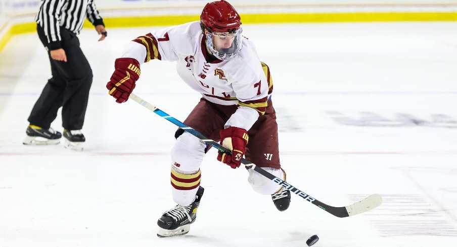 Aidan Hreschuk settles the puck as he skates down the ice for the Boston College Eagles