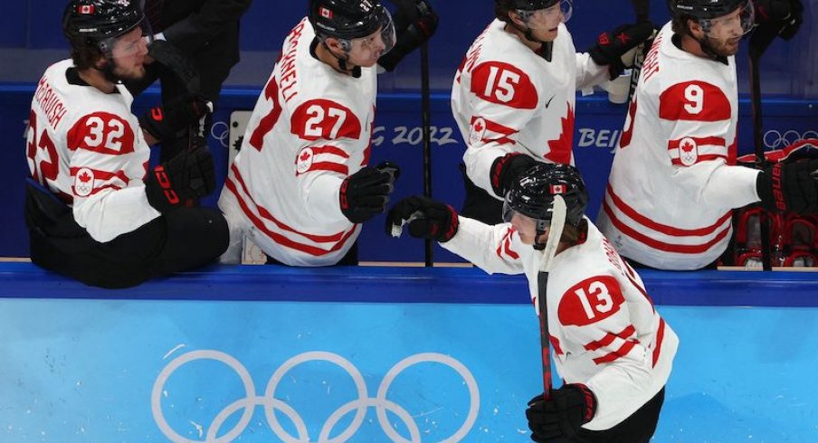 Team Canada's Kent Johnson celebrates a goal with teammates during Group A play versus China in the 2022 Winter Olympics in Beijing.