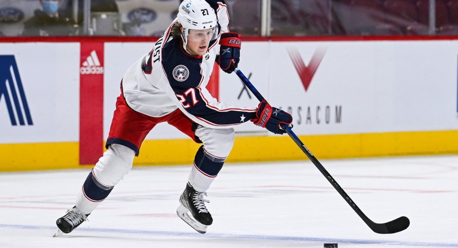 Adam Boqvist skates the puck