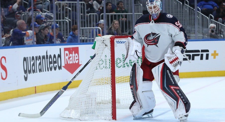 Columbus Blue Jackets goaltender Elvis Merzlikins (90) stick is stuck in the goal netting during the second period against the New York Islanders at UBS Arena. 