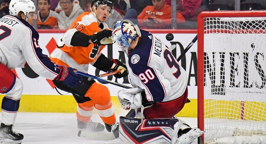 Columbus Blue Jackets goaltender Elvis Merzlikins (90) makes a save against Philadelphia Flyers left wing Joel Farabee (86) during the second period at Wells Fargo Center.