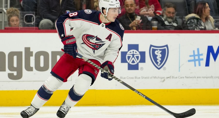 Zach Werenski skates with the puck during the second period against the Detroit Red Wings at Little Caesars Arena