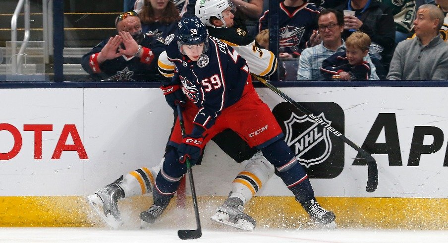 Columbus Blue Jackets' right winger Yegor Chinakhov checks Boston Bruins defenseman Charlie McAvoy during the first period at Nationwide Arena.