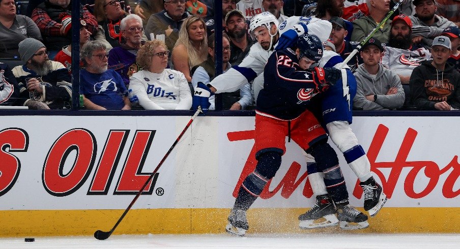 Columbus Blue Jackets defenseman Jake Bean checks Tampa Bay Lightning left wing Nicholas Paul along the boards in the third period at Nationwide Arena.