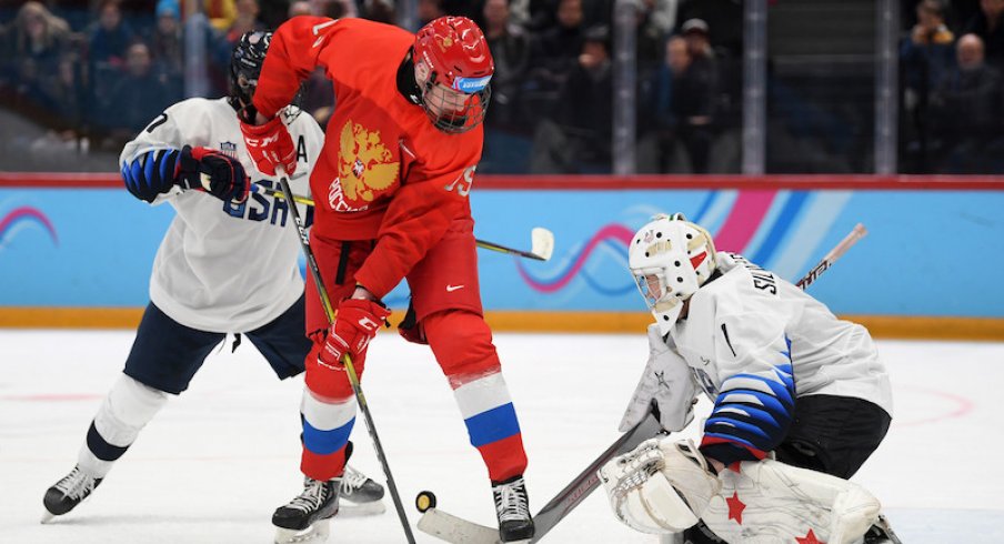 Kirill Dolzhenkov of Russia and Dylan Silverstein of USA battle for the puck during the Men's 6-Team Ice Hockey Tournament Finals Gold Medal Game between Russian Federation and United States on day 13 of the Lausanne 2020 Winter Youth Olympics at Lausanne Vaudoise Arena on January 22, 2020 in Lausanne, Switzerland.