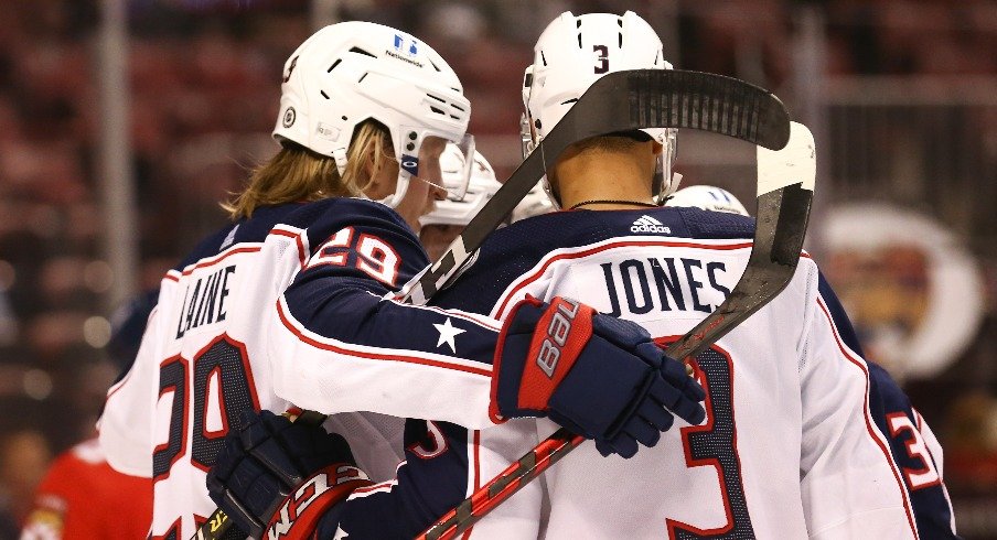 Columbus Blue Jackets right wing Patrik Laine and defenseman Seth Jones celebrate after a goal by center Jack Roslovic (not pictured) against the Florida Panthers during the first period at at Nationwide Arena.