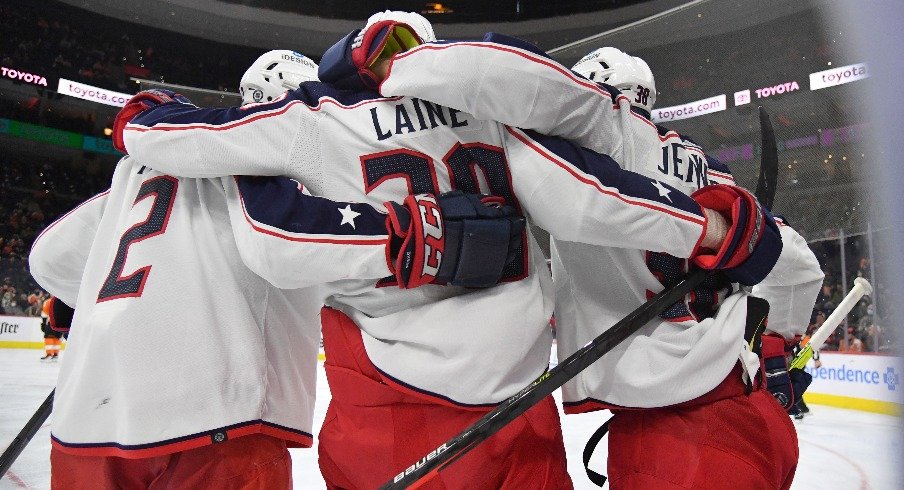 Columbus Blue Jackets left wing Patrik Laine celebrates his goal with defenseman Andrew Peeke and center Boone Jenner against the Philadelphia Flyers during the third period. 