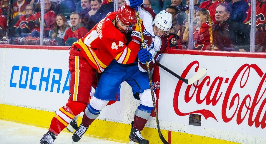 Colorado Avalanche left wing Artturi Lehkonen and Calgary Flames defenseman Erik Gudbranson battle for the puck during the second period at Scotiabank Saddledome.