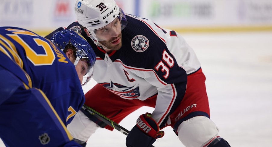 Buffalo Sabres' Tage Thompson and Columbus Blue Jackets' Boone Jenner wait for the face-off during the first period at KeyBank Center.