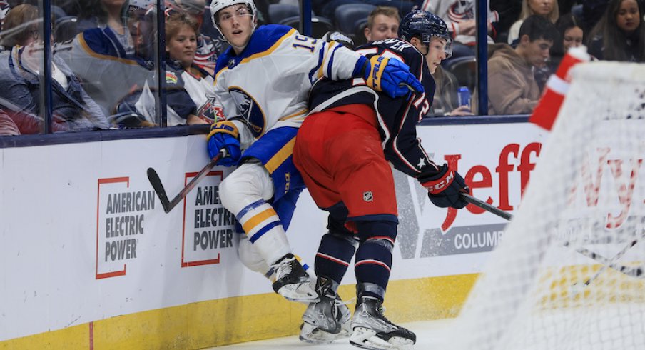 Columbus Blue Jackets' Carson Meyer checks Buffalo Sabres' Peyton Krebs along the boards in the third period at Nationwide Arena.