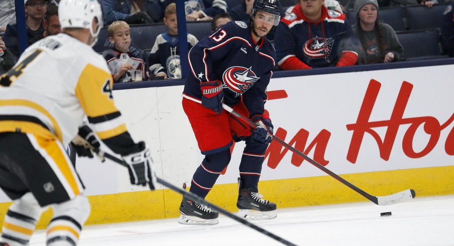 Johnny Gaudreau controls the puck against the Pittsburgh Penguins in his preseason debut