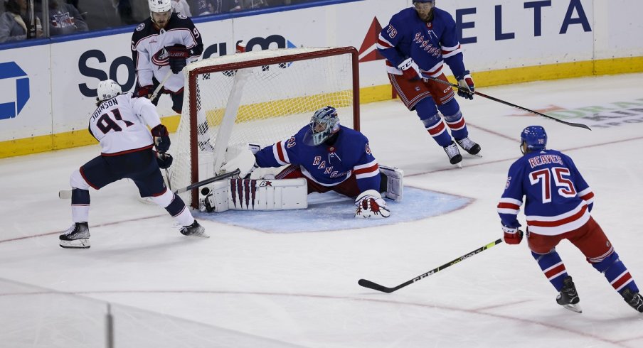 Kent Johnson scores a goal against New York Rangers goaltender Jaroslav Halak