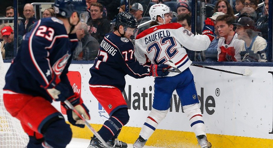 Columbus Blue Jackets defenseman Nick Blankenburg checks Montreal Canadiens right wing Cole Caufield during the first period at Nationwide Arena.