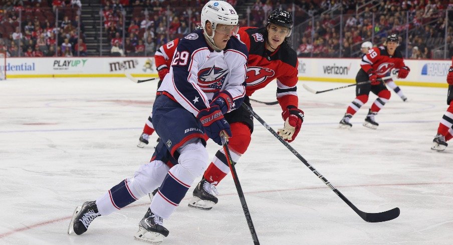 Columbus Blue Jackets left wing Patrik Laine skates with the puck while being defended by New Jersey Devils defenseman Ryan Graves during the first period at Prudential Center.