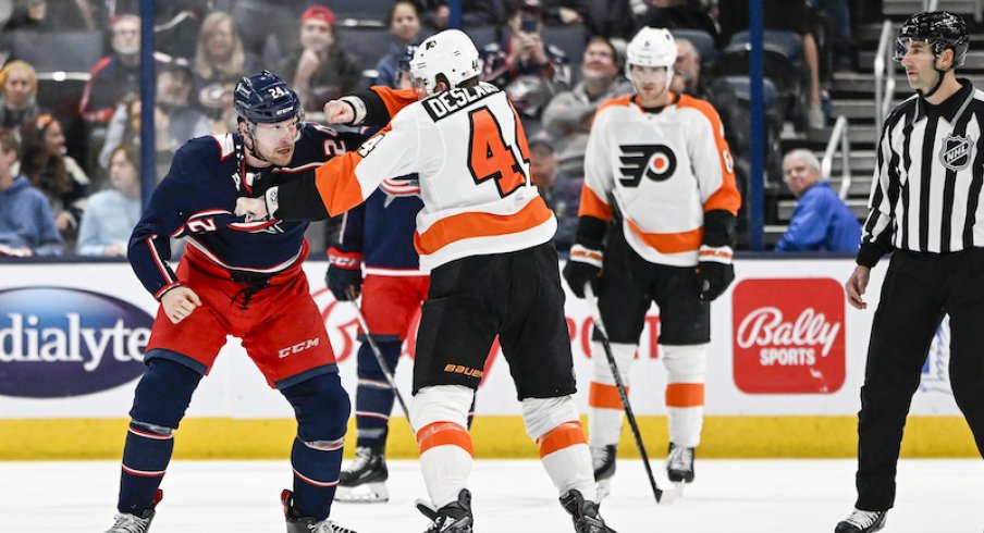 Columbus Blue Jackets' Mathieu Olivier and Philadelphia Flyers' Nicolas Deslauriers fight during the first period at Nationwide Arena.
