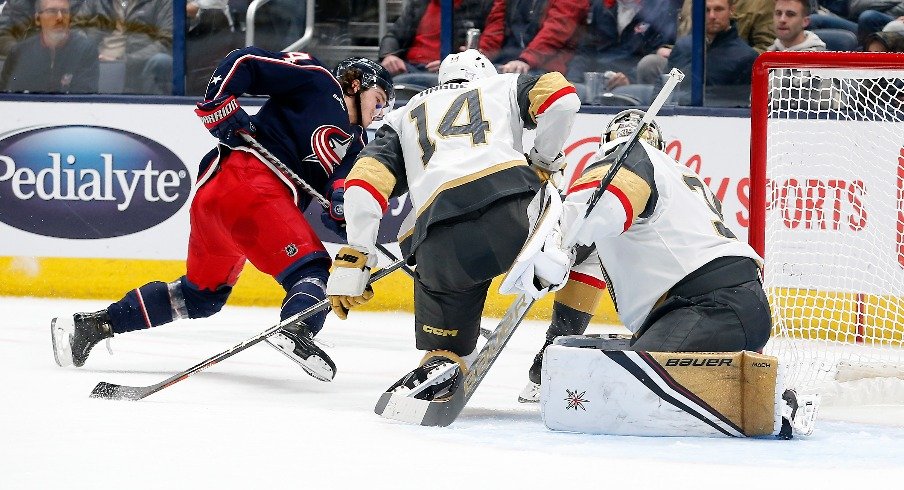 Columbus Blue Jackets center Cole Sillinger falls to the ice as he shoots against the Vegas Golden Knights during the first period at Nationwide Arena.