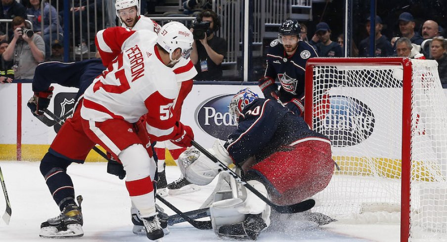 Columbus Blue Jackets' Joonas Korpisalo makes a save as Detroit Red Wings' David Perron looks for a rebound during the third period at Nationwide Arena.