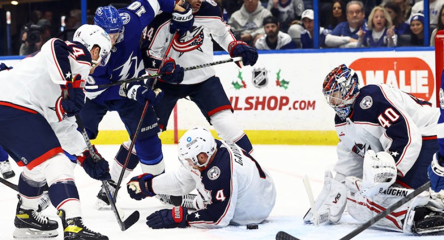 Tampa Bay Lightning' Corey Perry shoots the puck as Columbus Blue Jackets Vladislav Gavrikov and goaltender Daniil Tarasov defend during the first period at Amalie Arena.