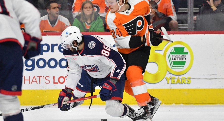 Columbus Blue Jackets right wing Kirill Marchenko and Philadelphia Flyers right wing Owen Tippett battle for the puck during the second period at Wells Fargo Center.