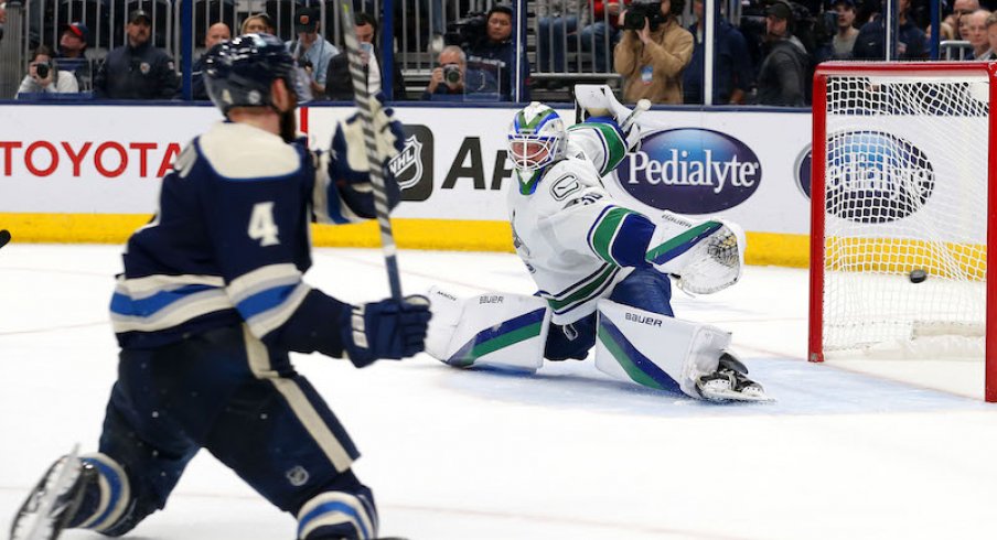 The shot from Columbus Blue Jackets' Vladislav Gavrikov gets past Vancouver Canucks' Spencer Martin for the game winner in overtime at Nationwide Arena.