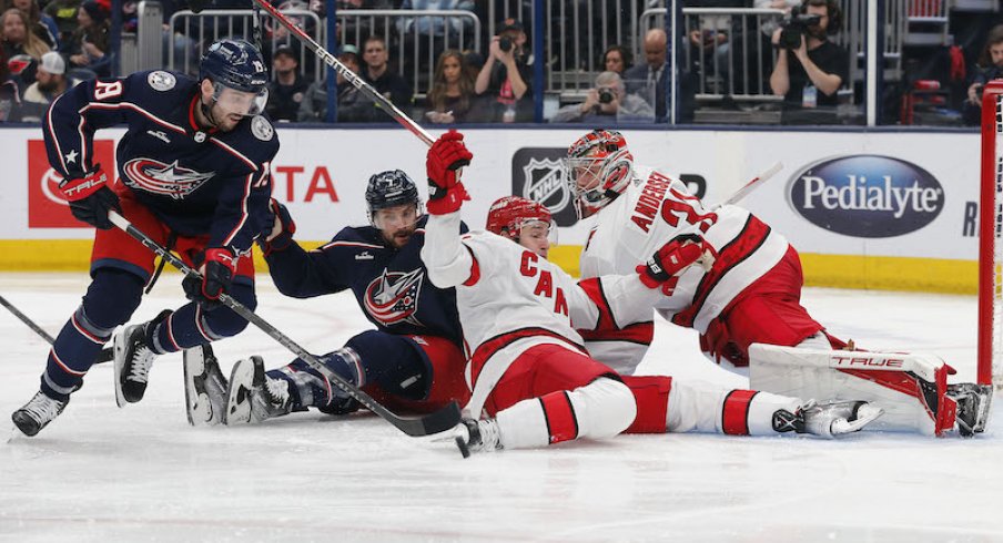 Columbus Blue Jackets' Liam Foudy picks up a rebound of a Carolina Hurricanes' Frederick Andersen save during the second period at Nationwide Arena.