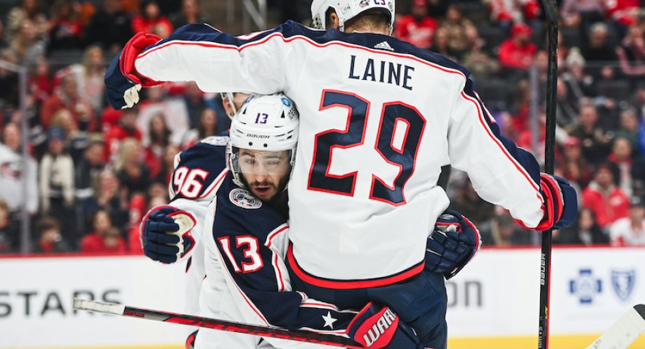 Columbus Blue Jackets' Patrik Laine celebrates his goal with Johnny Gaudreau during the first period against the Detroit Red Wings at Little Caesars Arena.