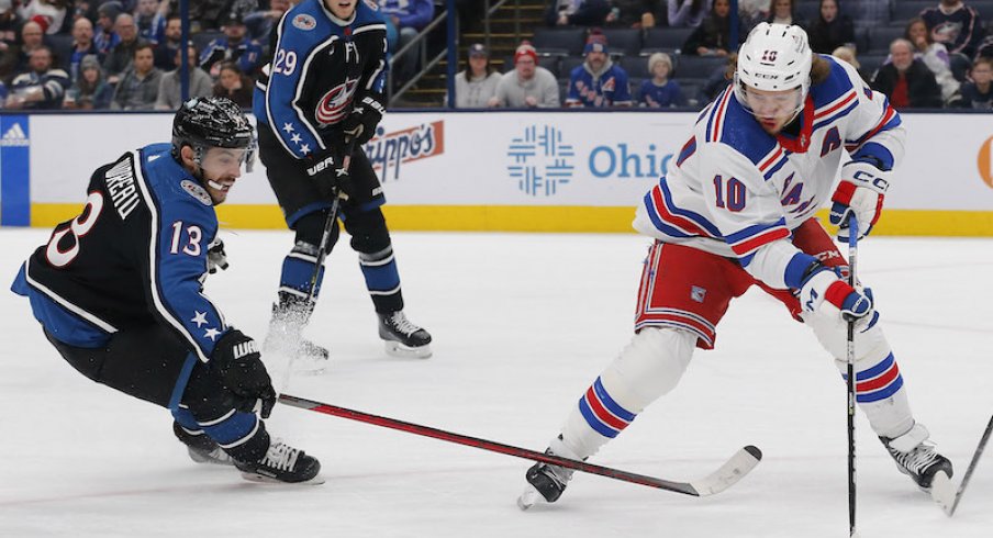 New York Rangers' Artemi Panarin and Columbus Blue Jackets' Johnny Gaudreau chase down a loose puck during the first period at Nationwide Arena.