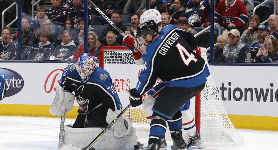Columbus Blue Jackets' Vladislav Gavrikov clears the puck from a Columbus Blue Jackets' Joonas Korpisalo save against the Montreal Canadiens during the second period at Nationwide Arena.