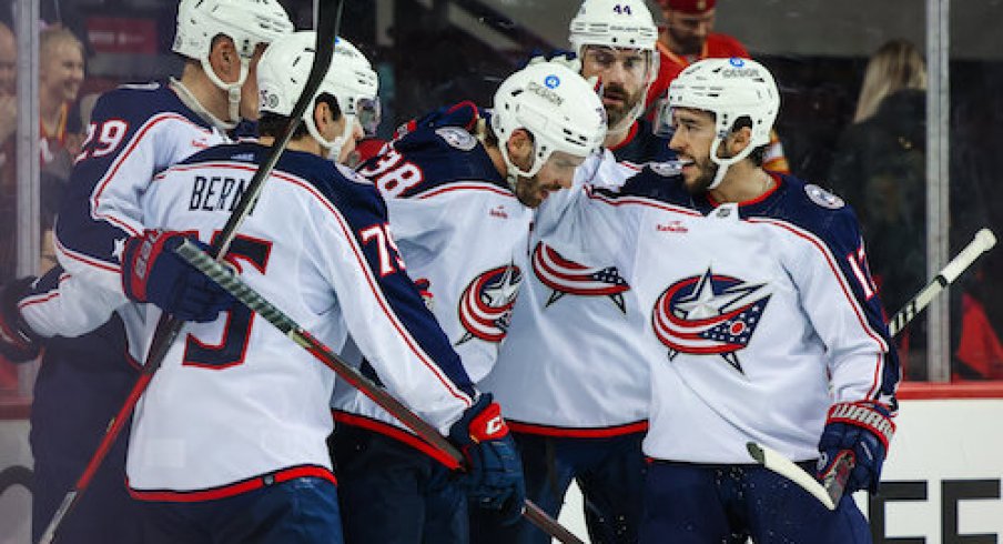 Blue Jackets celebrate after Boone Jenner's game-tying goal against the Flames.