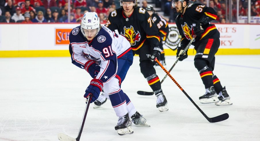 Kent Johnson skates with the puck against the Calgary Flames