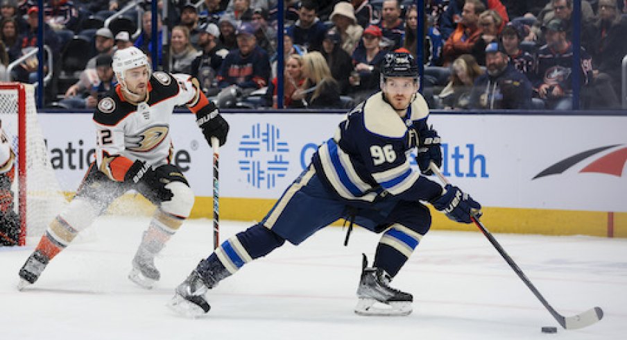 Jack Roslovic skates with the puck in the Ducks vs. Blue Jackets game.