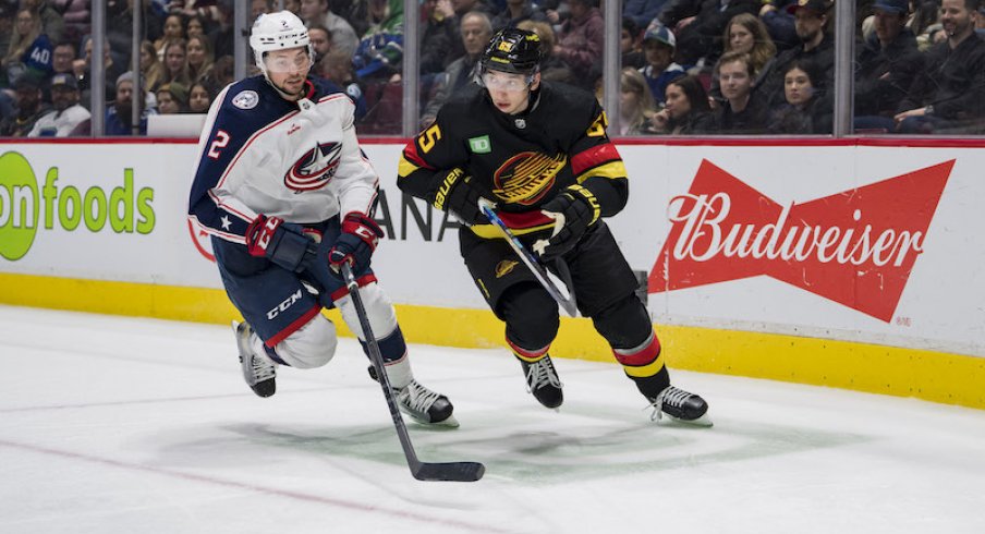 Columbus Blue Jackets' Andrew Peeke and Vancouver Canucks' Ilya Mikheyev battle for the loose puck in the third period at Rogers Arena. Canucks won 5-2.