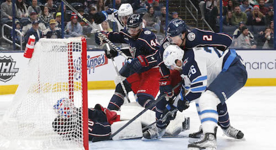 Joonas Korpisalo makes a save in the Blue Jackets vs. Jets game.