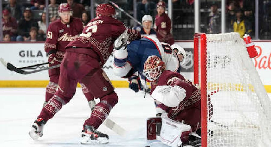 Patrik Nemeth checks Lane Pederson in the Coyotes-Blue Jackets game.