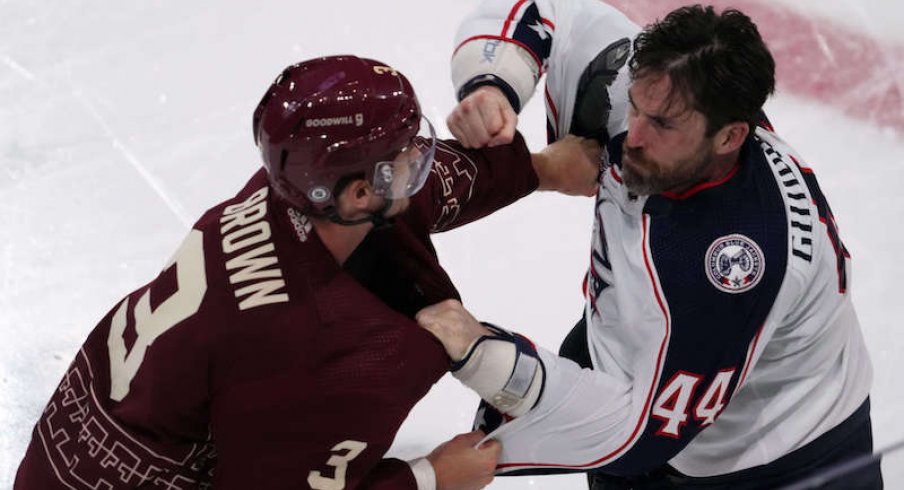 Arizona Coyotes' Josh Brown and Columbus Blue Jackets' Erik Gudbranson fight during the second period at Mullett Arena.