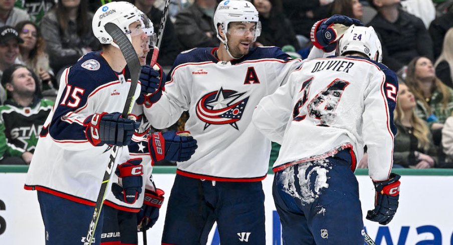 Columbus Blue Jackets' Gavin Bayreuther and Sean Kuraly and Mathieu Olivier skate off the ice after scoring a goal against the Dallas Stars during the third period at the American Airlines Center.