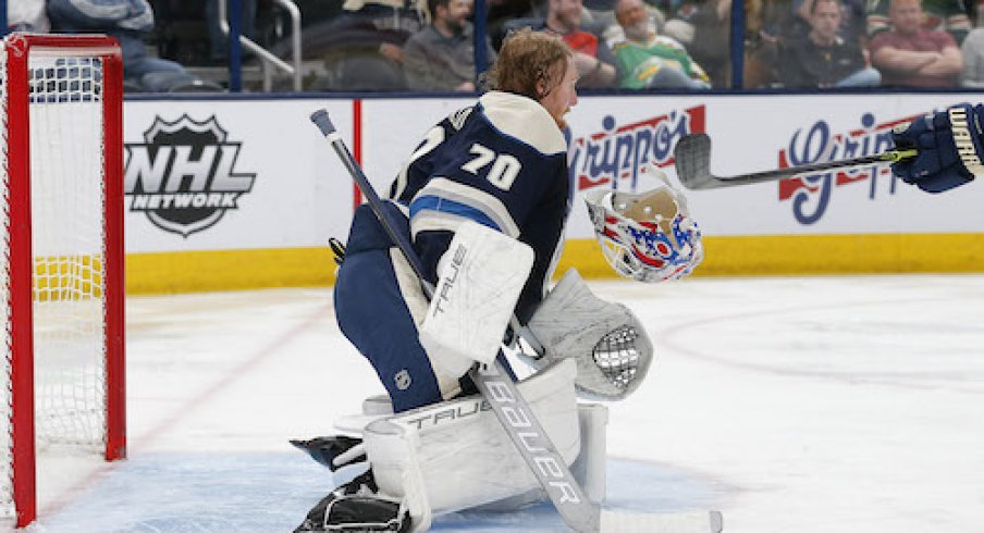 Joonas Korpisalo's mask falls off after making a save in the Wild vs. Blue Jackets game.