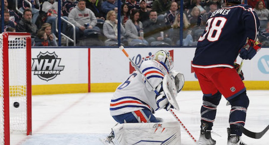 Boone Jenner deflects a shot past Jack Campbell in the Oilers vs. Blue Jackets game.