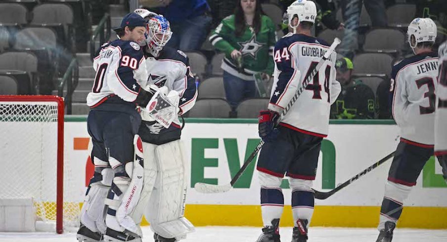 Columbus Blue Jackets' Elvis Merzlikins and Joonas Korpisalo and Erik Gudbranson celebrate the win over the Dallas Stars at the American Airlines Center.