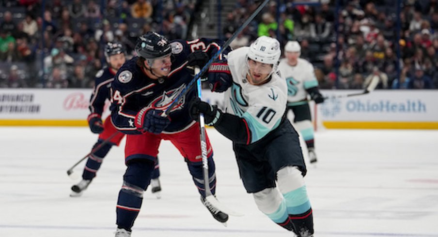 Cole Sillinger and Matty Beniers fight for position in the Kraken vs. Blue Jackets game.