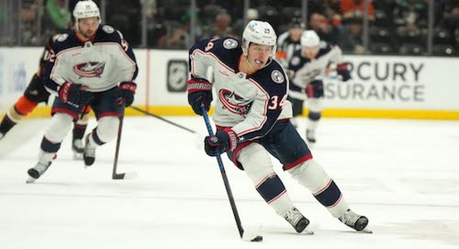 Cole Sillinger skates with the puck in the Blue Jackets vs. Ducks game. 