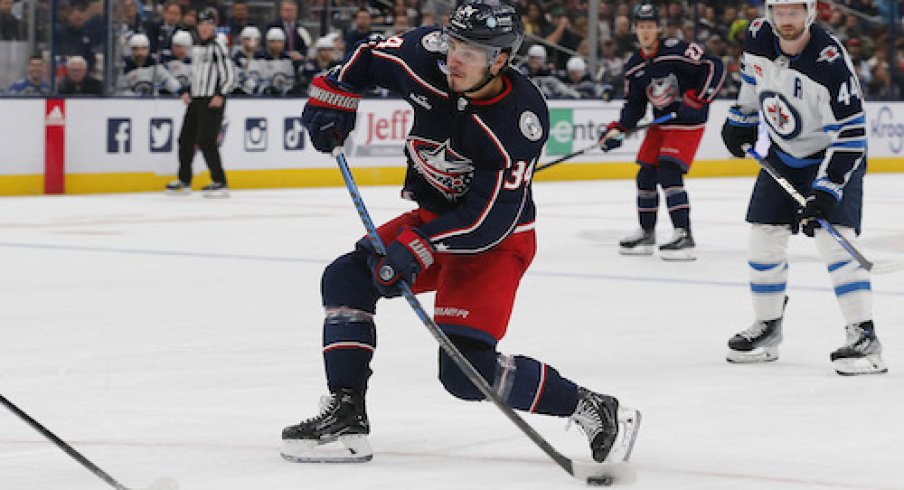 Cole Sillinger shoots the puck in the Jets vs. Blue Jackets game.