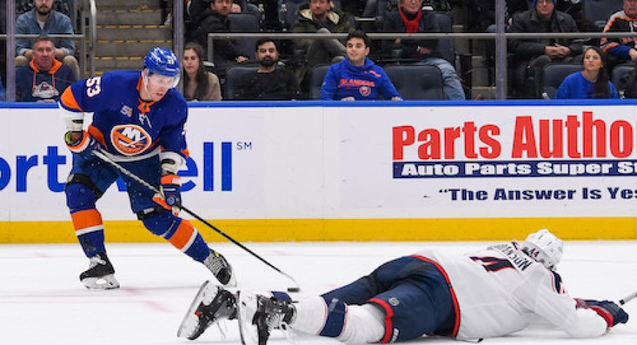 Casey Cizikas moves around Erik Gudbranson in the Islanders vs. Blue Jackets game.