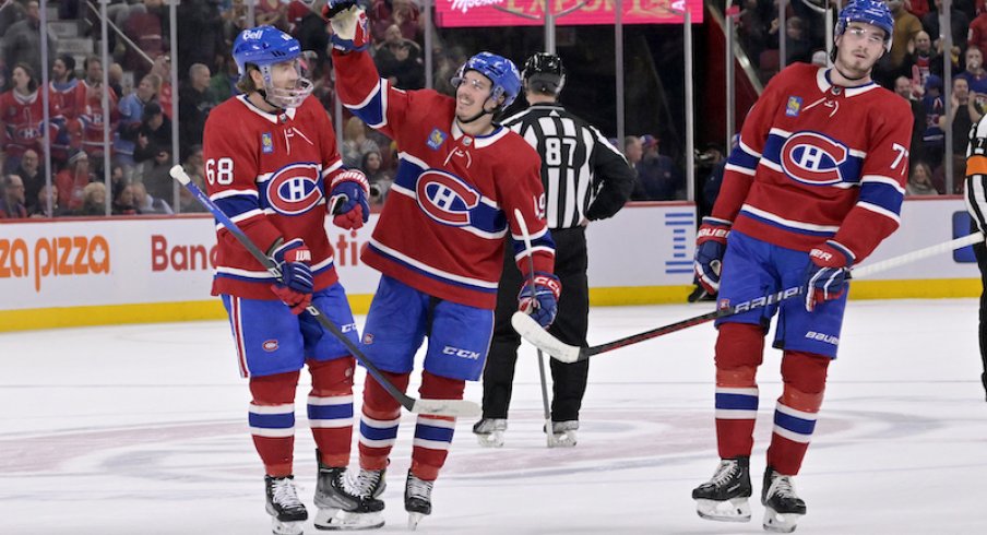 Montreal Canadiens' Rafael Harvey-Pinard celebrates with teammate Mike Hoffman and Kirby Dach after scoring his third goal against the Columbus Blue Jackets during the second period at the Bell Centre.