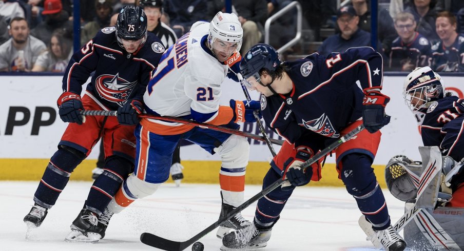 Tim Berni and Andrew Peeke battle against Kyle Palmieri 