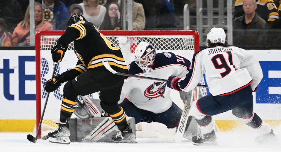 Boston Bruins' David Pastrnak scores a goal on Columbus Blue Jackets' Michael Hutchinson during overtime at the TD Garden.