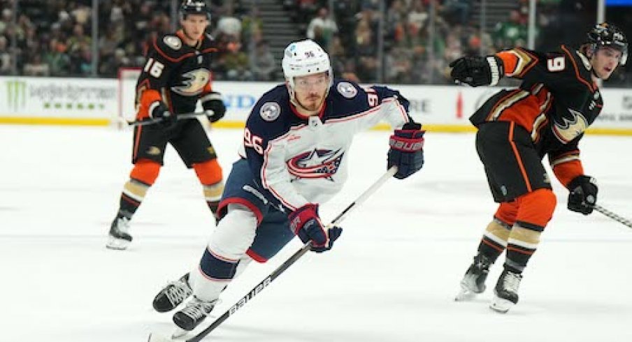 Jack Roslovic skates with the puck in the Ducks vs. Blue Jackets game.