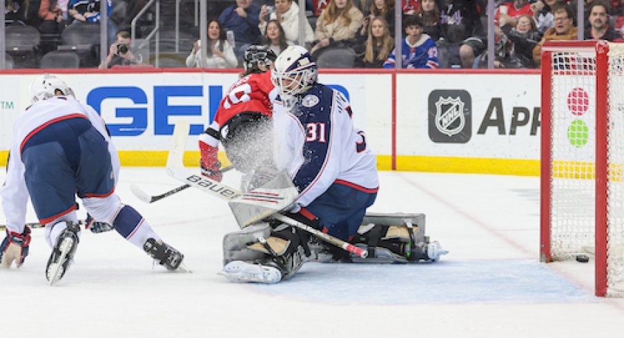 New Jersey Devils center Jack Hughes (86) scores a goal past Columbus Blue Jackets goaltender Michael Hutchinson (31) during the first period at Prudential Center.